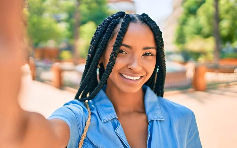 Smiling young African American woman with beautifully done box braids